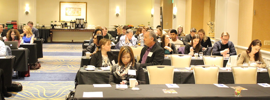 Attendees at a Customer SuccessCon event, seated at tables