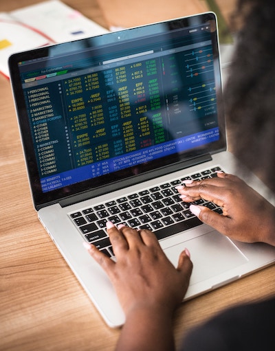 Image of a laptop screen and keyboard with two hands