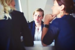 2 women facing 1 woman