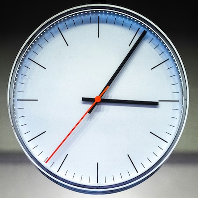 Image of clock face with hands showing 6 after 3