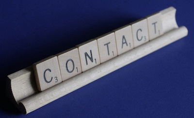 Letters spelling Contact on a scrabble game
