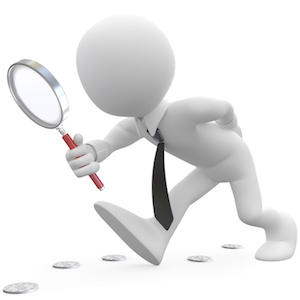 Image of a man walking while looking through a magnifying glass